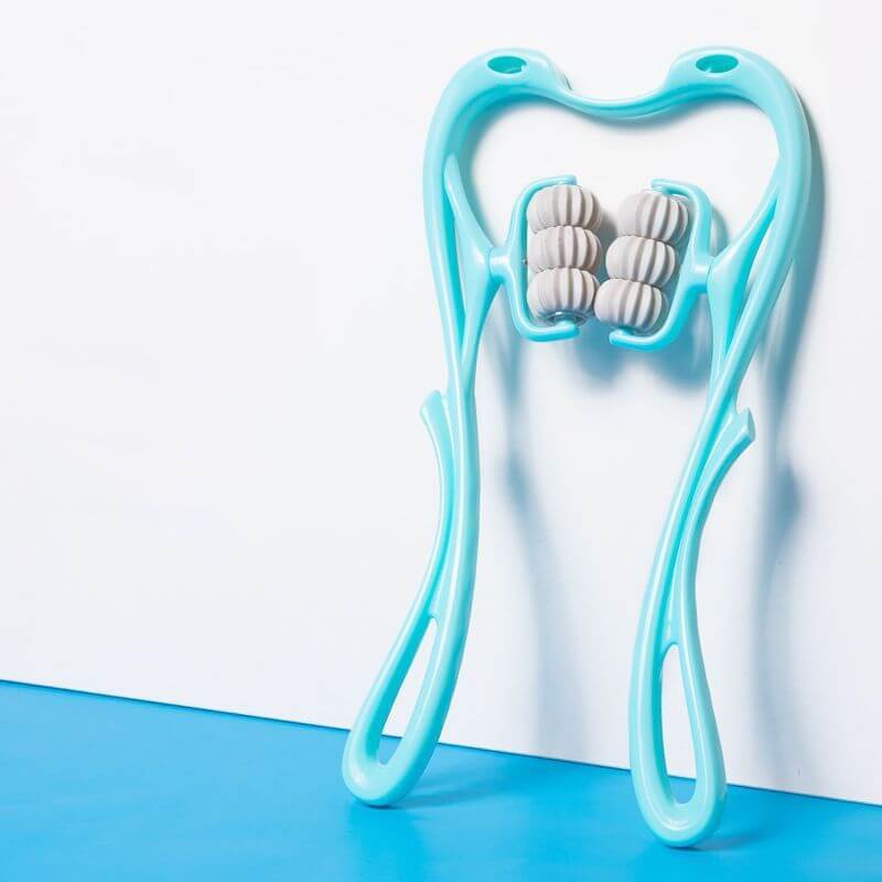 Multifunctional Manual Six-wheel Neck Massager Massage Relieve Roller Massage Tool in turquoise color against a blue background.